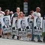 Workers holding signs supporting Arthur T. Demoulas march outside the company?s distribution center in Andover.